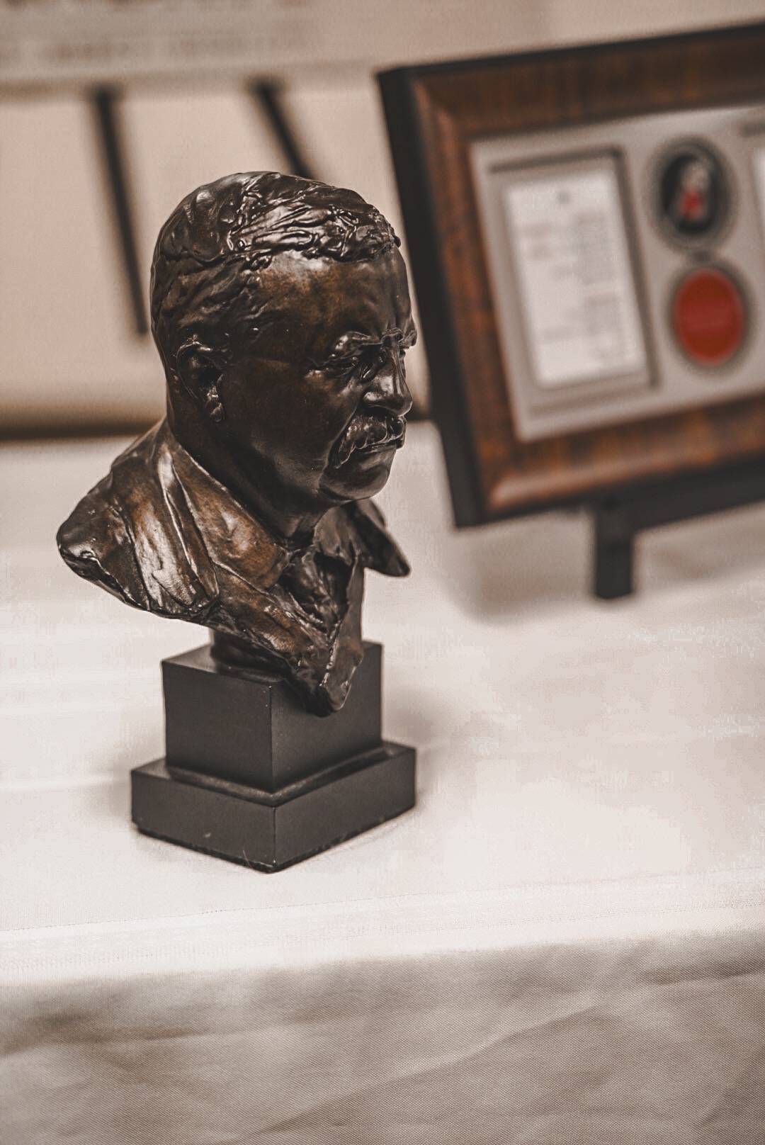 A bronze bust of Theodore Roosevelt on a table at a Micah Mandate gathering
