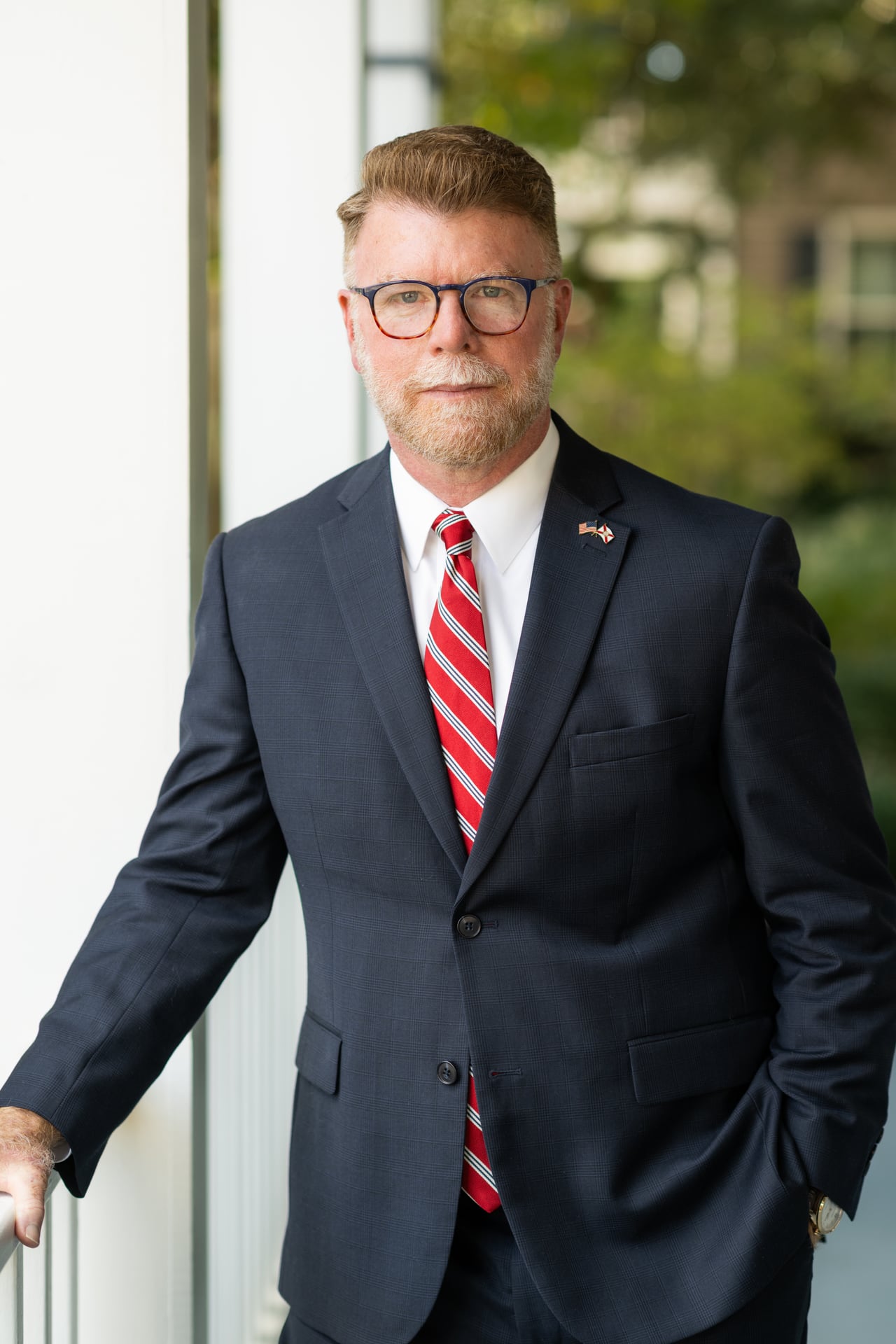 Portrait of Todd Leonard in a navy suit and striped tie